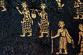 Wat Xieng Thong temple in Luang Prabang, Laos. Detail of the  intricate gold stencilling on black lacquer that decorate the walls of the sim. 